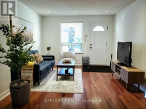 Toronto (Danforth Village-East York) apartment for rent - A living room with a blue couch and a wooden floor.