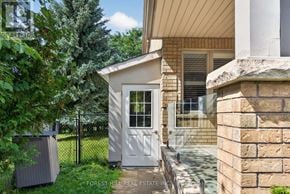 Vaughan (Beverley Glen) apartment for rent - A small white door is on the side of a house.