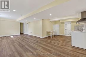 Vaughan (Beverley Glen) apartment for rent - A spacious room with wooden flooring and a white kitchenette.