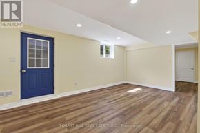 Vaughan (Beverley Glen) apartment for rent - A room with a blue door and wooden flooring.