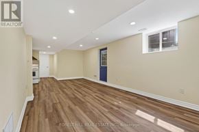 Vaughan (Beverley Glen) apartment for rent - A room with wooden flooring and a window with a view of trees.