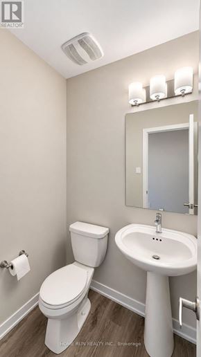 Ottawa townhouse for rent - A white toilet and sink in a small bathroom.