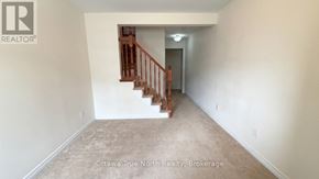 Ottawa townhouse for rent - A room with a staircase and a brokerage logo.
