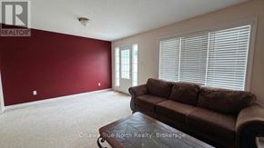 Ottawa townhouse for rent - A living room with a brown couch and a window with blinds.