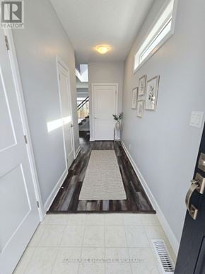 Kingston (City Northwest) apartment for rent - A hallway with a rug on the floor and pictures on the wall.