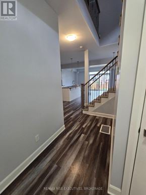 Kingston (City Northwest) apartment for rent - A hallway with wood flooring and a staircase.