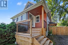 Ottawa apartment for rent - A house with a red siding and a wooden deck.