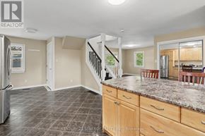 Ottawa apartment for rent - A kitchen with granite countertops and wooden cabinets.