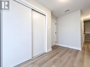 Ottawa townhouse for rent - A white room with a sliding door and wooden flooring.