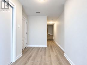 Ottawa townhouse for rent - A hallway with wooden floors and white walls.