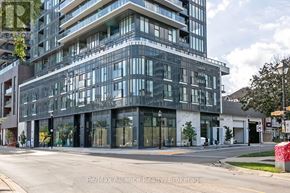 Burlington (Brant) condo for rent - A modern multi-story building with glass windows and balconies.