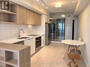 Toronto (Flemingdon Park) condo for rent - A kitchen with wooden cabinets and a white countertop.