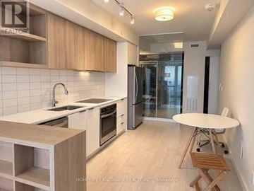 Toronto (Flemingdon Park) condo for rent - A kitchen with wooden cabinets and a white countertop.