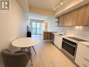 Toronto (Flemingdon Park) condo for rent - A kitchen with a table and chairs in the foreground and a window in the background.