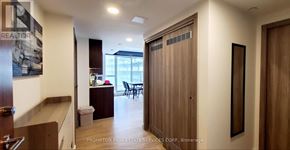 Toronto (Waterfront Communities) condo for rent - A hallway with a sign that says "REALTOR" on the wall.