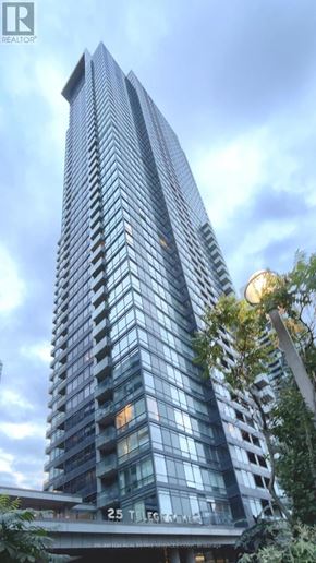 Toronto (Waterfront Communities) condo for rent - A tall building with many windows and balconies is shown in the image.