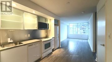 Toronto (Waterfront Communities) condo for rent - A kitchen with stainless steel appliances and wooden floors.