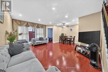 Toronto (Morningside) townhouse for rent - A living room with a grey sofa and a wooden floor.