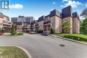 Toronto (Morningside) townhouse for rent - A street view of a residential area with a building that has a sign RE/MAX COMMUNITY REALTY INC., Brokerage.