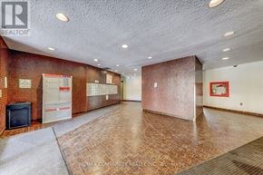 Toronto (Morningside) townhouse for rent - A large empty room with a brick wall and a television.