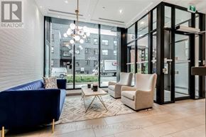 Toronto (South Riverdale) condo for rent - A brokerage office for Forest Hill Real Estate Inc. is shown with a blue couch, a coffee table, and a chandelier.