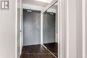 Toronto (South Riverdale) condo for rent - A hallway with two doors and a brokerage logo.