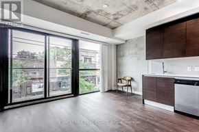 Toronto (South Riverdale) condo for rent - A modern kitchen with a dining chair and a view of the city.