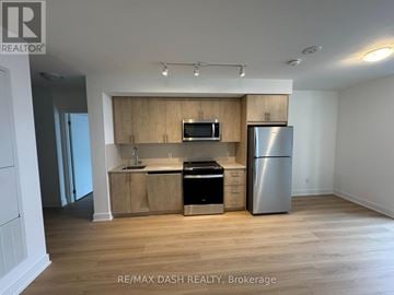 Oshawa (Windfields) condo for rent - A kitchen with wooden cabinets and stainless steel appliances.