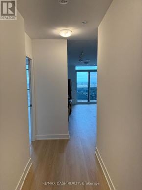 Oshawa (Windfields) condo for rent - A hallway with a door leading to a balcony.