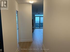 Oshawa (Windfields) condo for rent - A hallway with a door leading to a balcony.