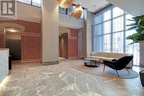 Toronto (East End-Danforth) condo for rent - A living room with a brick wall and a large window.