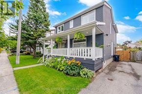 Toronto (O'connor-Parkview) apartment for rent - A house with a grey facade and white railings is for sale.