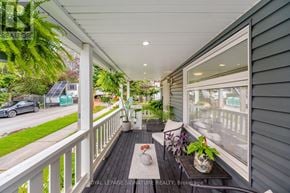 Toronto (O'connor-Parkview) apartment for rent - A balcony with a table and chairs overlooking a street.