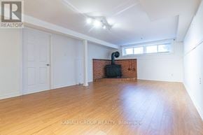Newmarket (Bristol-London) apartment for rent - A room with wooden flooring and a brick fireplace is on the market with Kamali Group Realty.