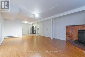 Newmarket (Bristol-London) apartment for rent - A spacious living room with wood flooring and a brick fireplace.