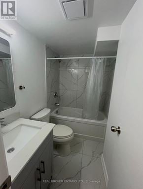 Markham (Milliken Mills West) apartment for rent - A bathroom with a toilet, sink, and bathtub.
