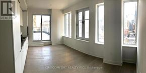 Toronto (Bay Street Corridor) condo for rent - A spacious room with a view of the city through large windows.