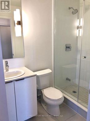 Toronto (Bay Street Corridor) condo for rent - A white toilet sits next to a sink in a bathroom.