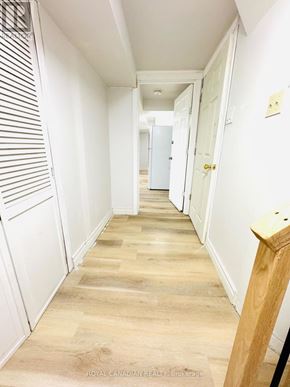 Ajax (Central) apartment for rent - A long hallway with white walls and wood flooring.