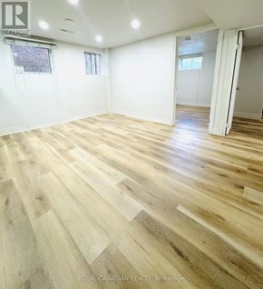 Ajax (Central) apartment for rent - A room with wooden flooring and white walls.