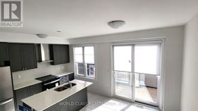 Whitby (Port Whitby) townhouse for rent - A kitchen with a stove top oven and a sink.