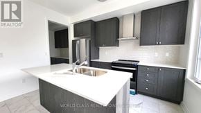Whitby (Port Whitby) townhouse for rent - A kitchen with a white countertop and black cabinets.