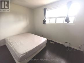 Toronto (L'amoreaux) apartment for rent - A white bed with a white mattress in a room with a window.