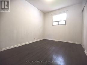 Toronto (L'amoreaux) apartment for rent - A room with a window and wooden flooring.