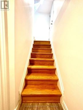 Toronto (Milliken) apartment for rent - A wooden staircase leading up to a white door.