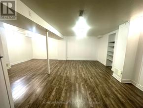 Toronto (Milliken) apartment for rent - A room with wooden flooring and white walls.