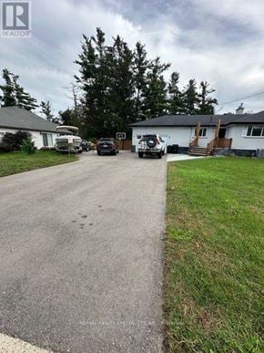 Barrie (Allandale Heights) apartment for rent - A realtor photo of a residential area with houses and cars.
