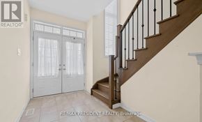 Thorold (Hurricane/Merrittville) apartment for rent - A hallway with a staircase and a glass door.