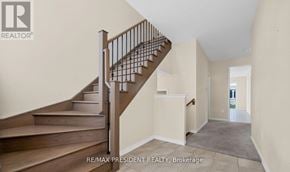 Thorold (Hurricane/Merrittville) apartment for rent - A staircase with a metal railing and wooden steps.