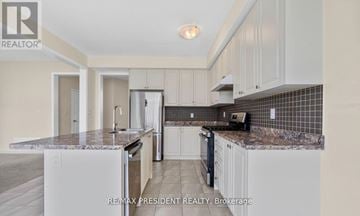 Thorold (Hurricane/Merrittville) apartment for rent - A kitchen with white cabinets and a granite countertop.
